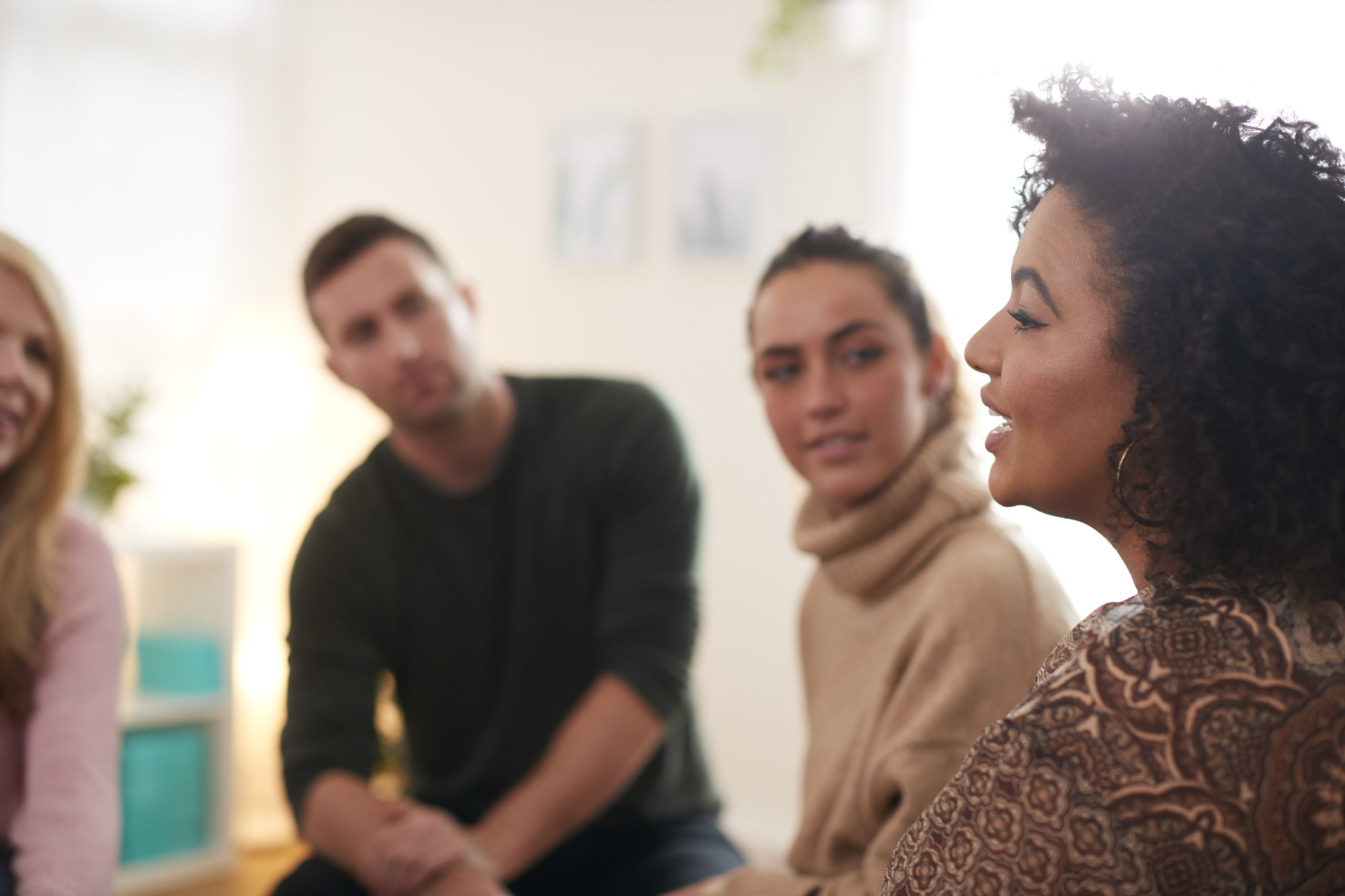 Woman Speaking At Support Group Meeting For Mental Health Or Dependency Issues In Community Space