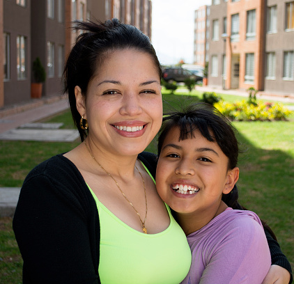 Happy mother and daughter laughing outdoor.