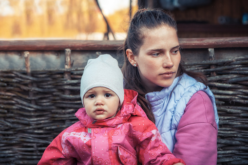 Single mother embracing her baby child girl family lifestyle portrait