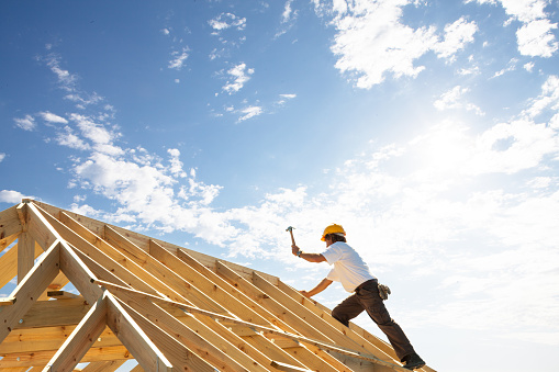 Man building a house with a hammer, recovery is his journey he is building a new life