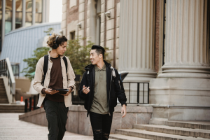 Two college students are walking to class. 