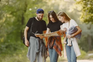 A group of three students is looking at recovery material while walking to class. 