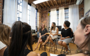 People listening to speakers at a conference.