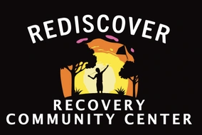 Logo of Rediscover Recovery Community Center. It is an illustration that has the colors of black, orange, and yellow that showing a person reaching their right arm over their shoulder in a forest area. 
