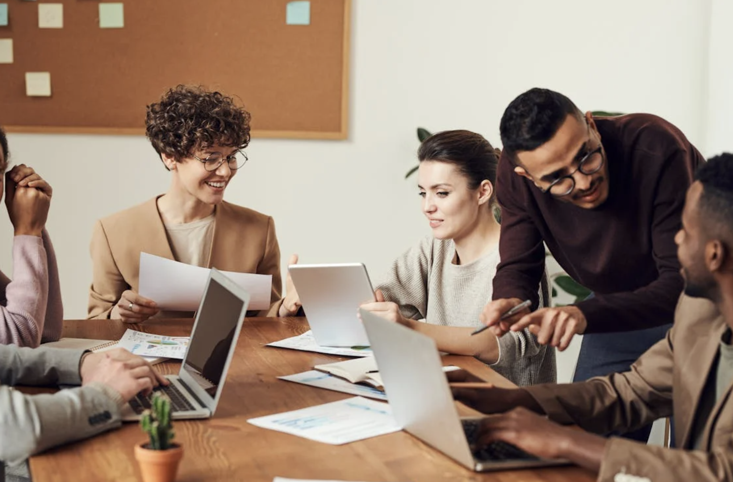 A group of people sitting around a table talking about a project.