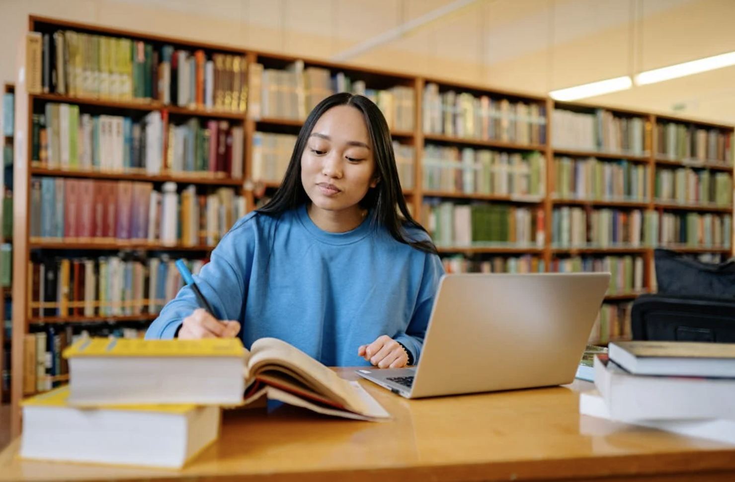 A female student studying for an exam in the library.