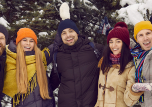 College students outside in winter smiling in a group
