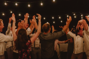 People dancing under string lights