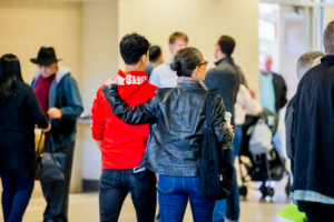 Several people walking around a building at an event
